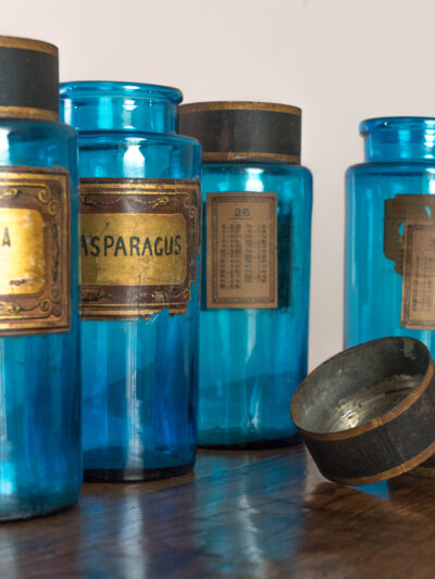 A Set of Five Large Antique Blue Glass French Apothecary Jars An original set of French 19th century apothecary or chemists jars with tole caps and paper labels, in a beautiful and rare blue glass. Dimensions: H:  28 cm W: 11.5 cm