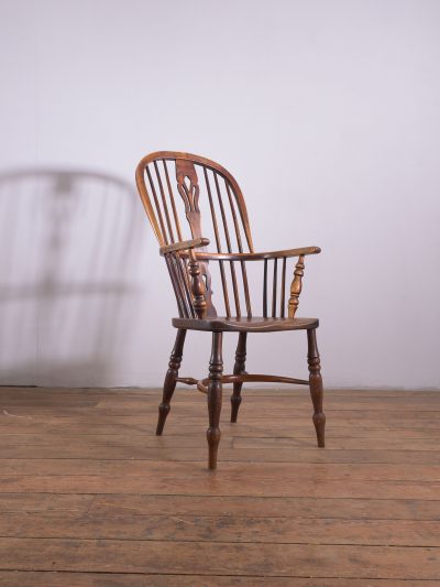 A 19th Century Elm and Ash Windsor chair with a pierced splat back and crinoline stretcher. 